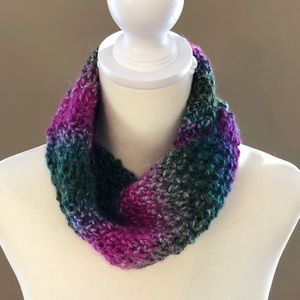 Cowl hand knit in jewel toned yarn.